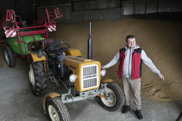 With unsold grain piled high, a Polish farmer faces an uncertain future as war in Ukraine grinds on