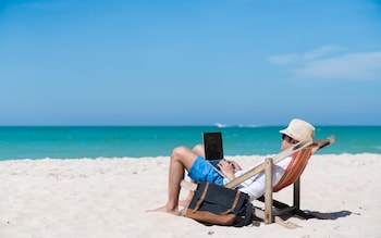 Working from the beach could result in a double tax bill, accountants warn