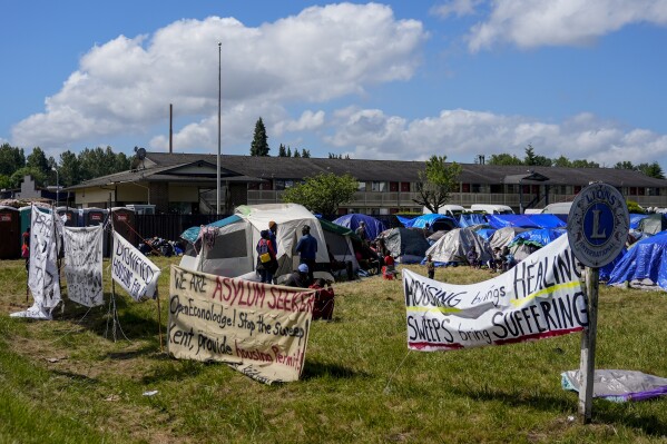 Hundreds of asylum-seekers are camped out near Seattle. There’s a vacant motel next door