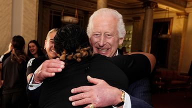 King Charles giggles as he finds himself in middle of New Zealand rugby players' hug